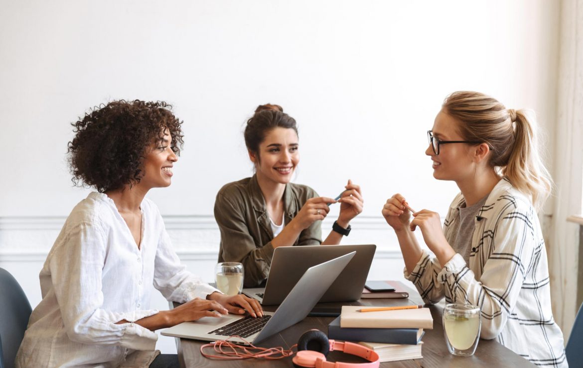 group-of-cheerful-young-women-studying-together-AHK5QF2