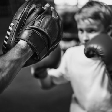Boy Boxing Training Punch Mitts Exercise Concept