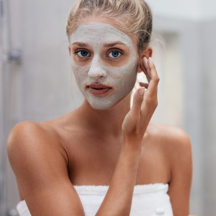 woman-applying-facial-mask-in-bathroom-2021-04-06-08-43-26-utc