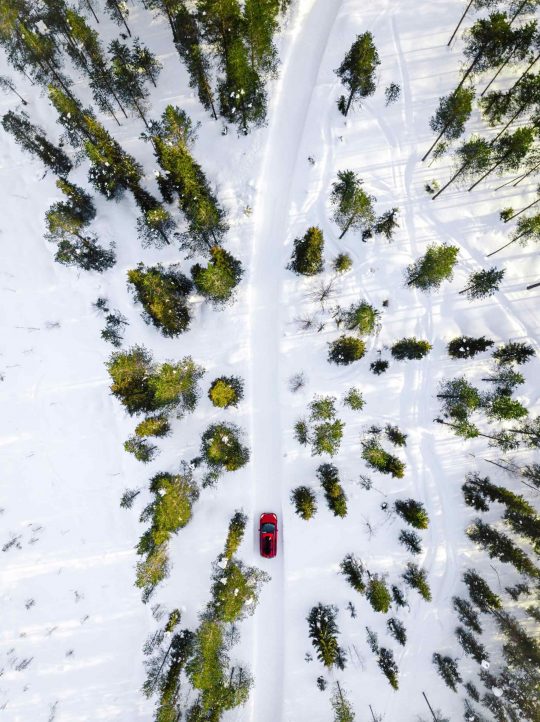 aerial-view-of-red-car-driving-through-the-white-s-NBZCPLJ