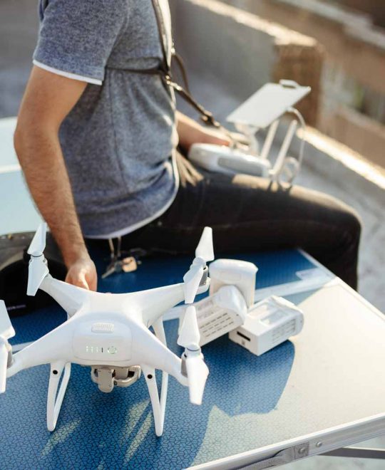 man-with-drone-flying-at-the-city-on-rooftop-KLF9A8N