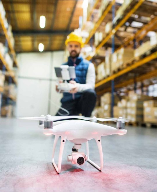 man-with-drone-in-a-warehouse-PMQEJ35