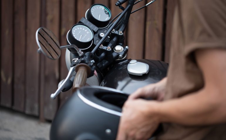 biker-guy-isits-on-classic-style-motorcycle-N6UXFBA