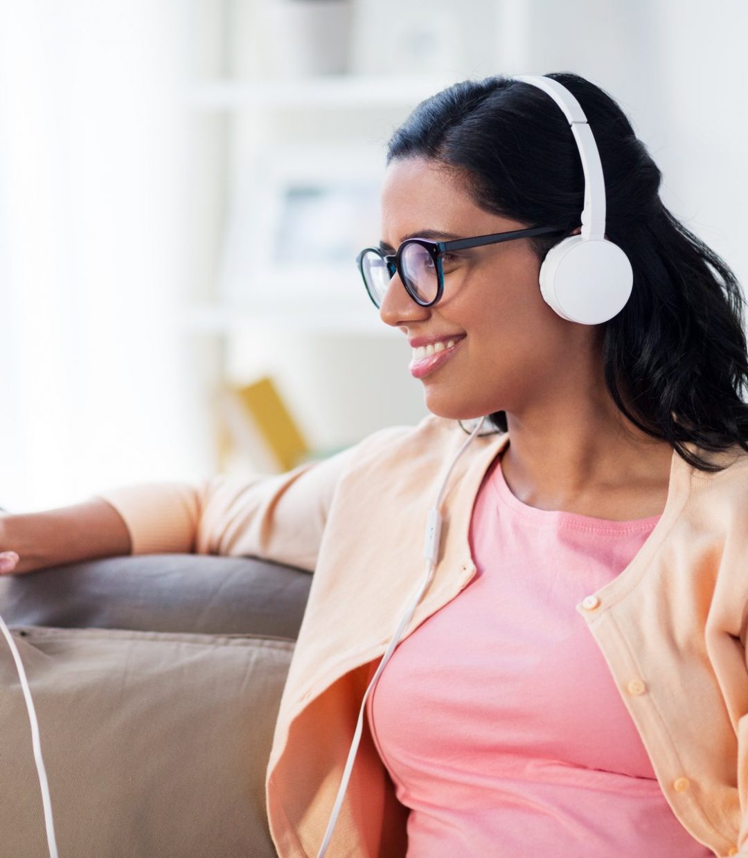 happy-woman-with-tablet-pc-and-headphones-at-home-P32QZJA