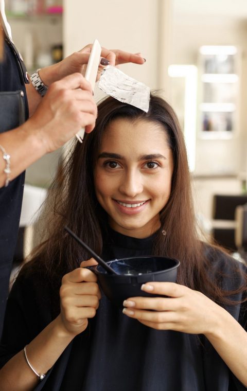 hairdresser-makes-hairstyle-to-female-customer-SAD5VL2