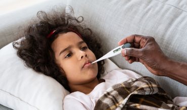 world-pandemic-sick-little-girl-with-high-fever-an-XSA2L9F